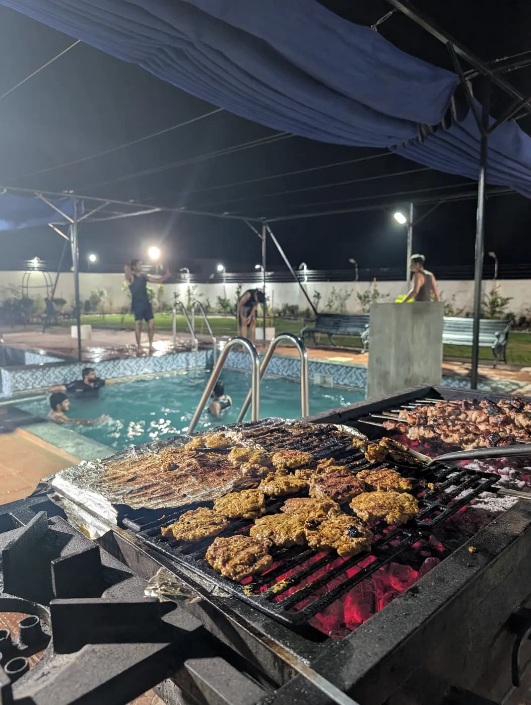 Evening BBQ by the pool at Kosam Farms