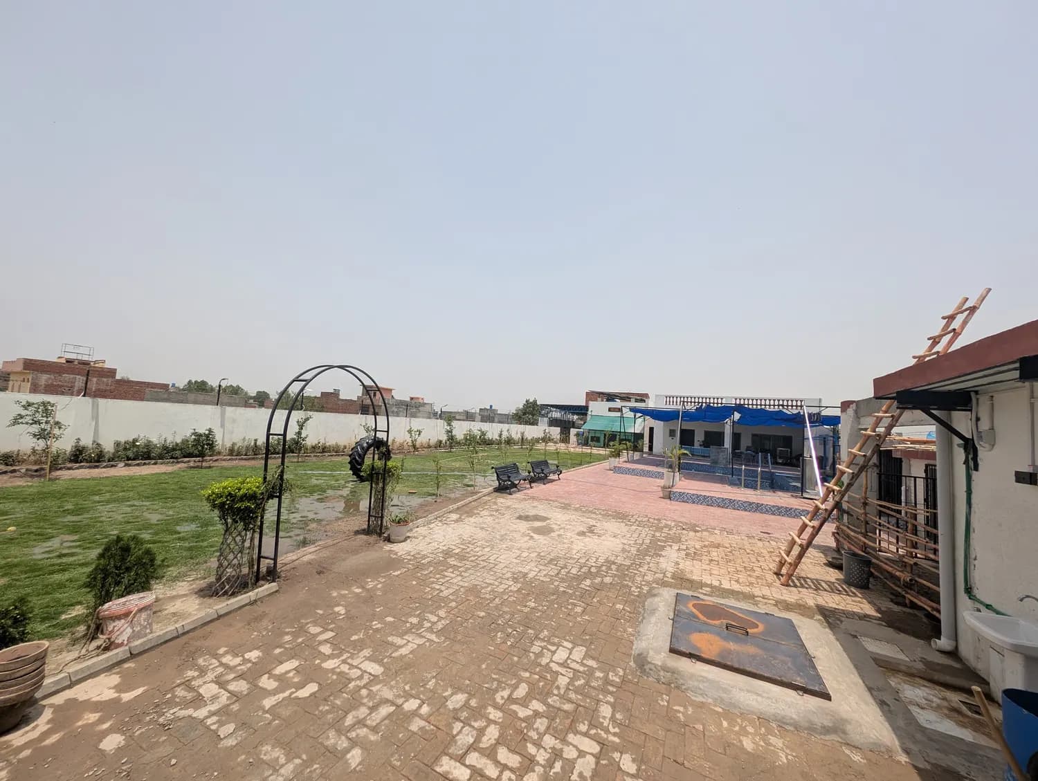 Kosam Farms lawn with garden arch and brick pathway
