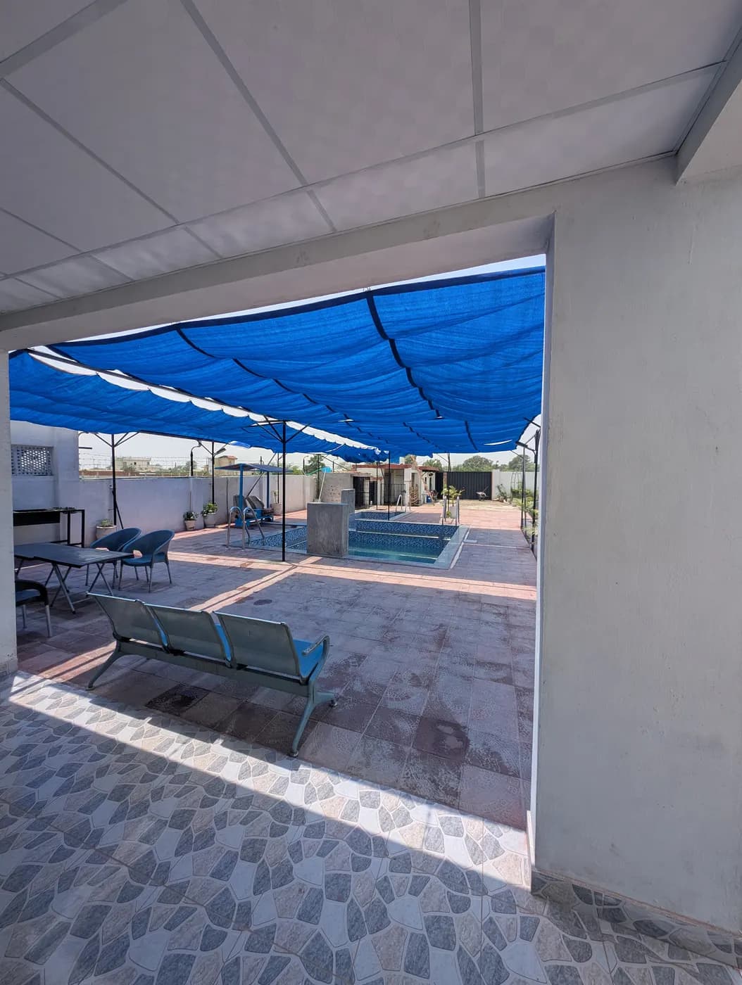 Kosam Farms covered terrace seating overlooking the pool