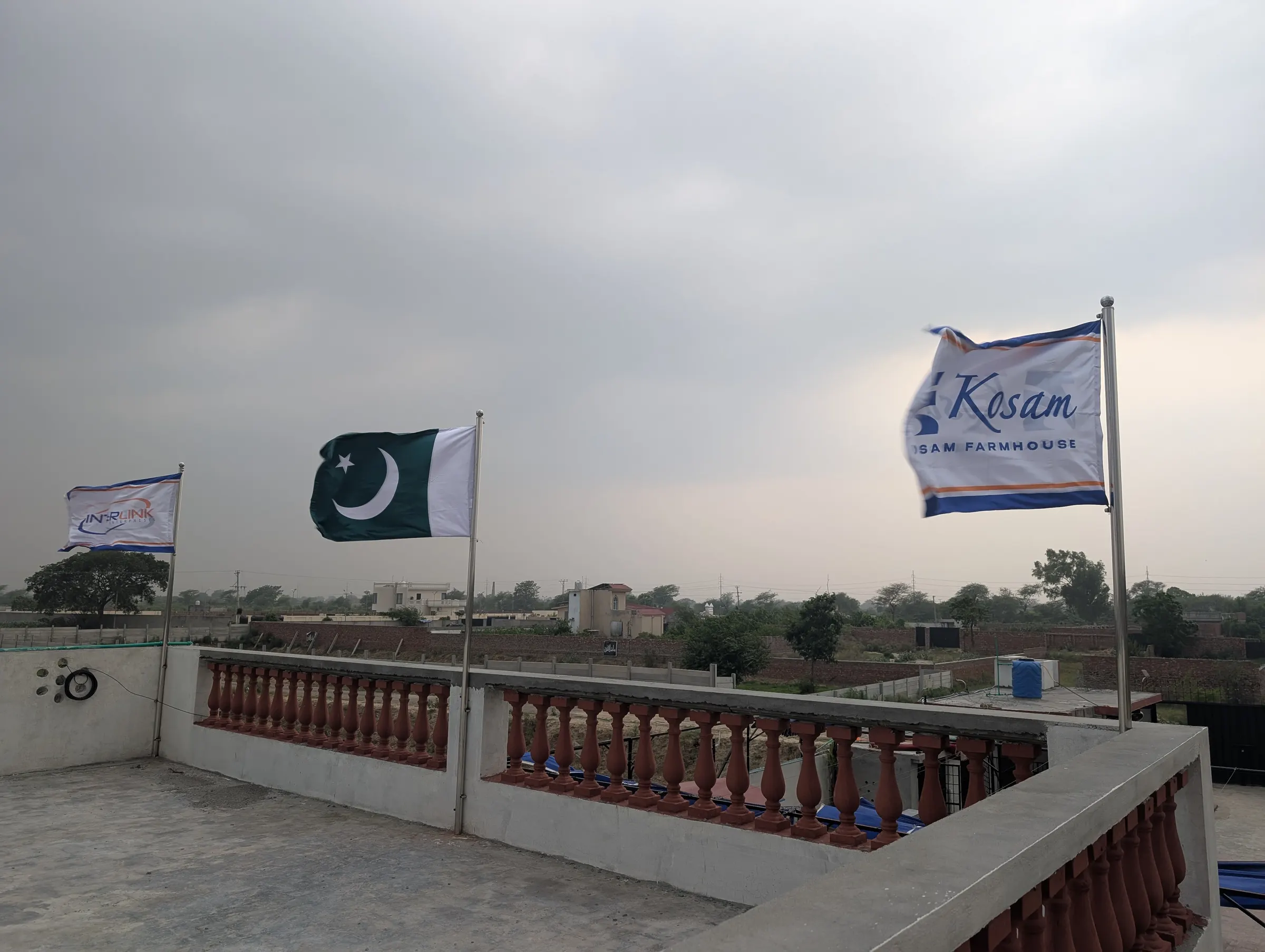 Kosam Farms rooftop terrace with the property flag flying over the grounds